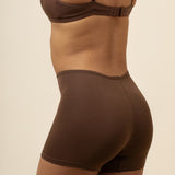 Model showcasing the back side of the Women's Boxer in Toffee and straps of the matching bra