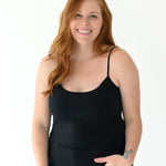 Female model wearing the Women’s Camisole in Midnight paired with medium wash jeans