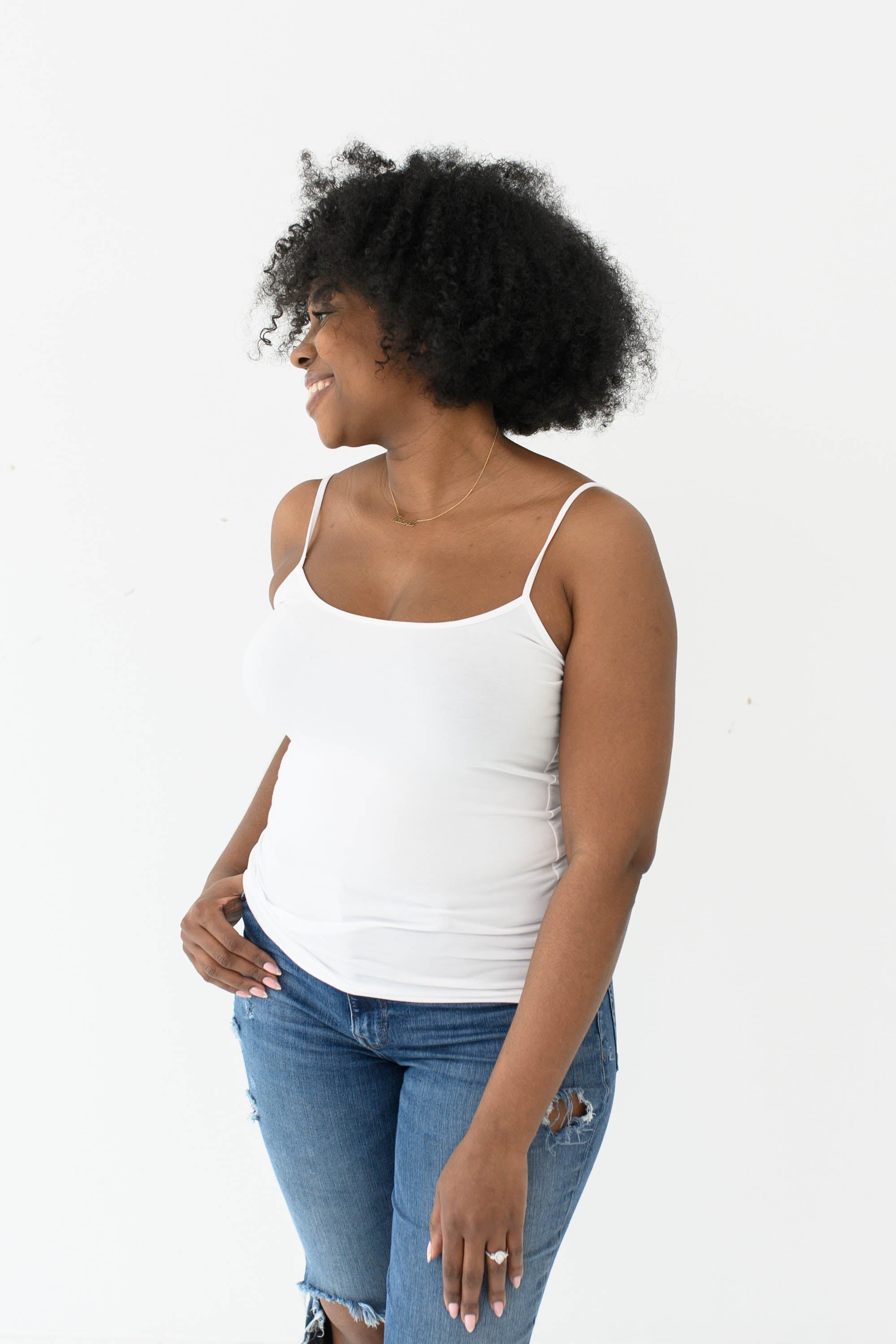 Model in the Women’s Camisole in Snow paired with medium wash jeans