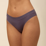 Purple underwear worn by a person on a beige background