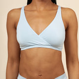 Close up of a model wearing the Women's Cross Front Bralette in Breeze paired with matching briefs ::: Model is 32C wearing size S ///