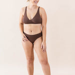 Model wearing Kyte Baby's Women's Cross Front Bralette in Toffee
