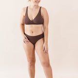 Model wearing Kyte Baby's Women's Cross Front Bralette in Toffee