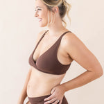 Side view of model wearing Kyte Baby's Women's Cross Front Bralette in Toffee