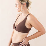 Side view of model wearing Kyte Baby's Women's Cross Front Bralette in Toffee