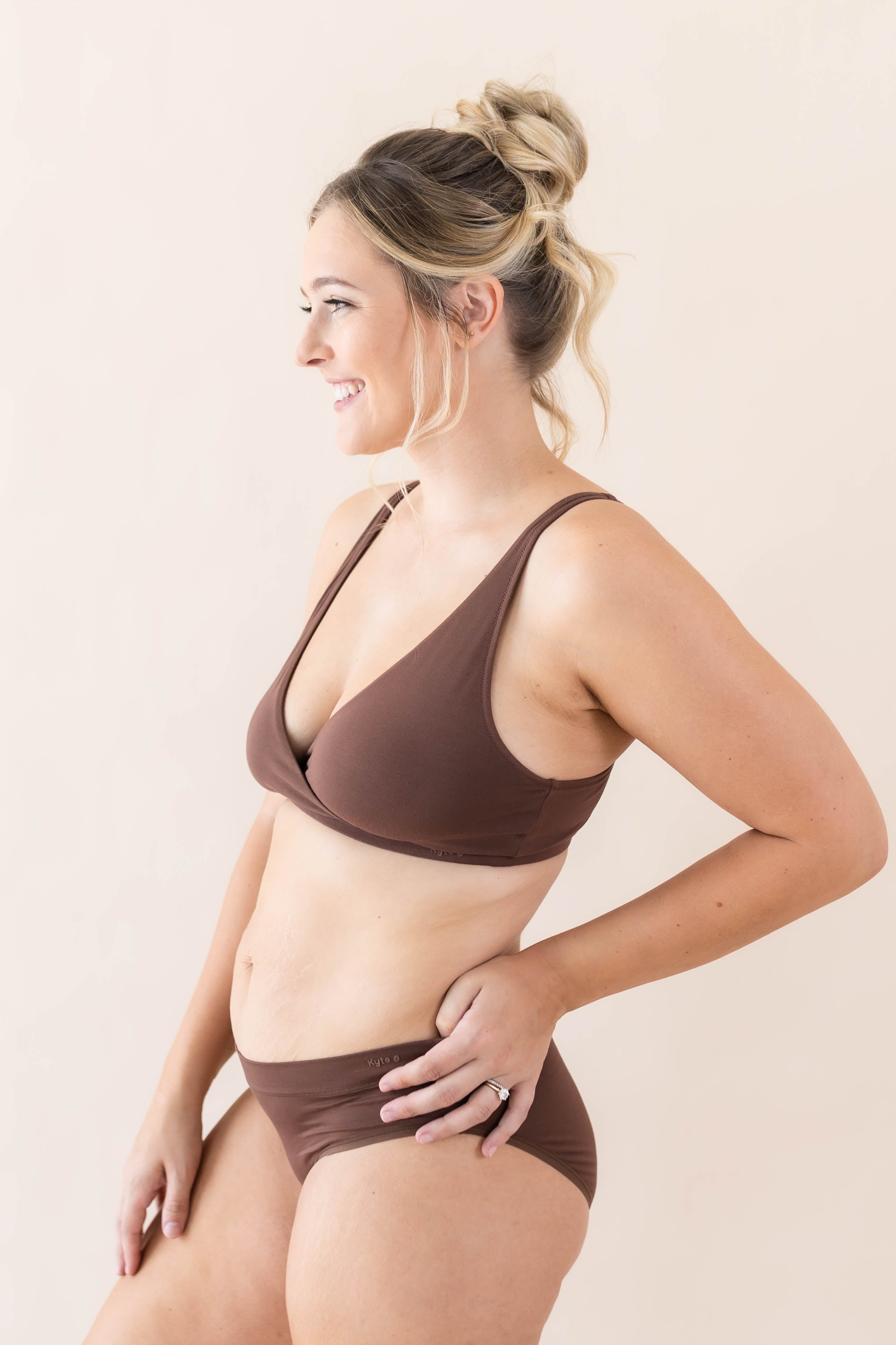 Side view of model wearing Kyte Baby's Women's Cross Front Bralette in Toffee