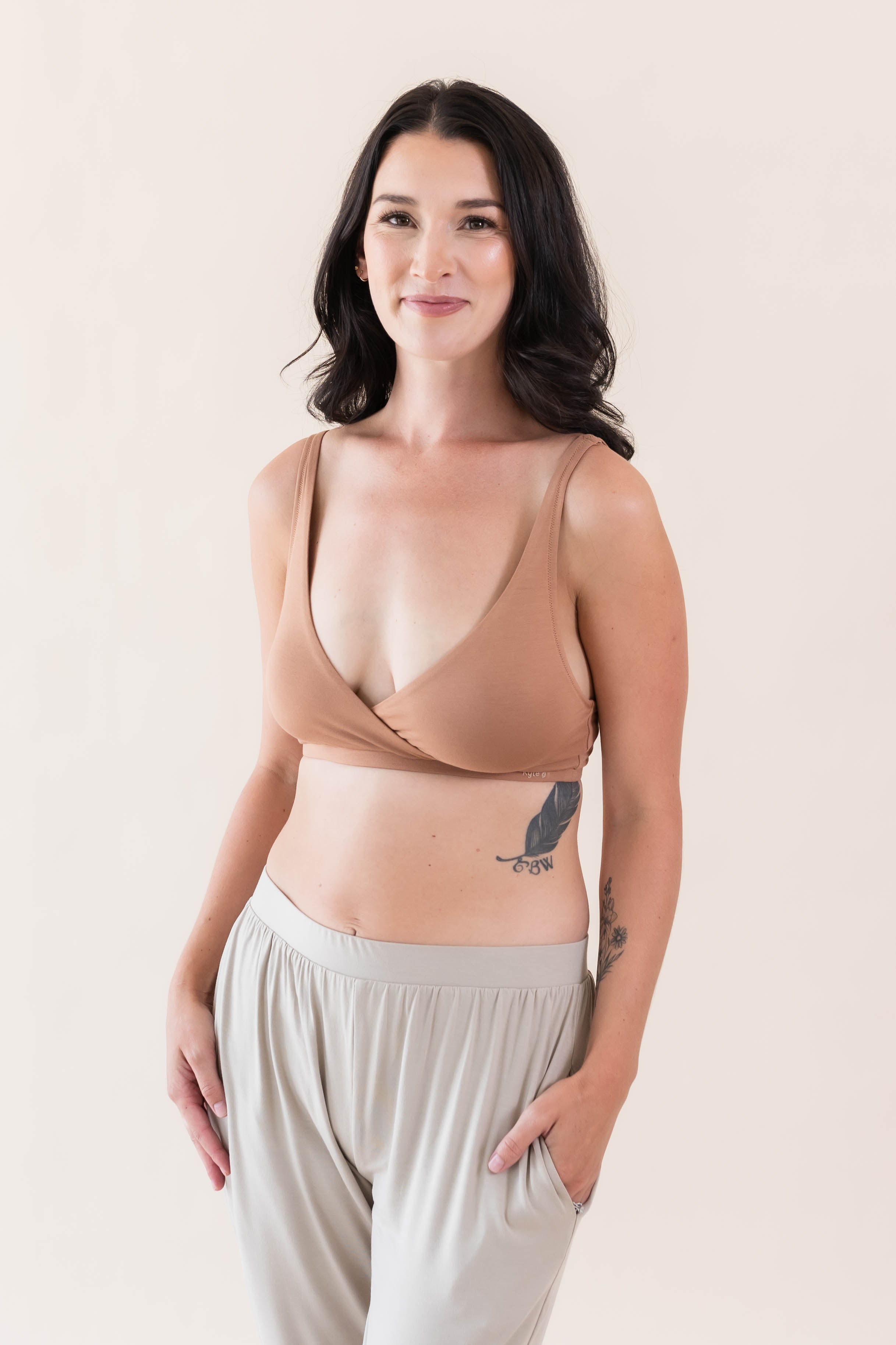 Woman wearing Kyte Baby's Women's Cross Front Bralette in Latte