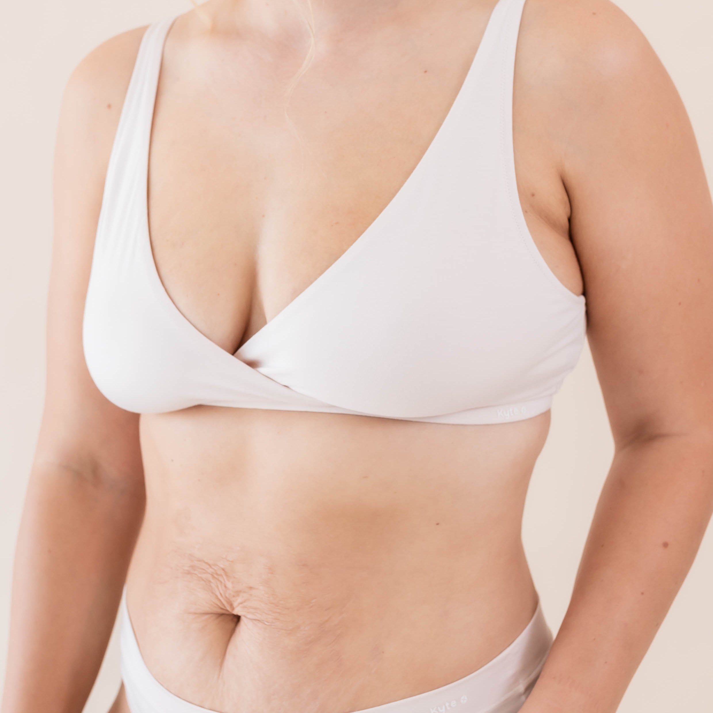 Woman in Cross Front Bralette in Blonde light nude and matching undies