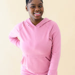 Female wearing the Women's French Terry Nursing Hoodie in Apple Blossom paired with light wash jeans