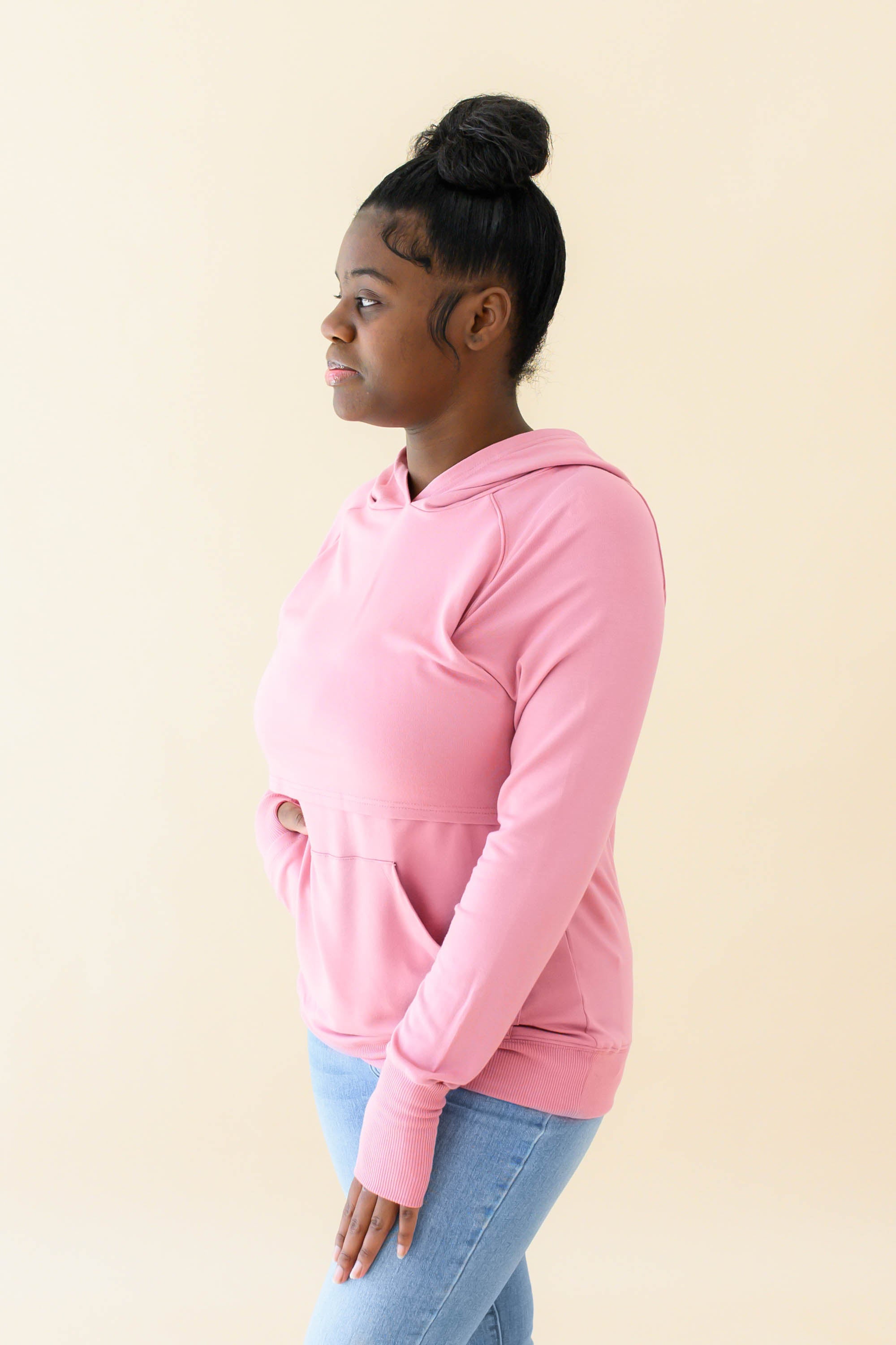 Female wearing the Women's French Terry Nursing Hoodie in Apple Blossom and light wash jeans