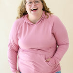 Female wearing the Women's French Terry Nursing Hoodie in Apple Blossom in light wash jeans