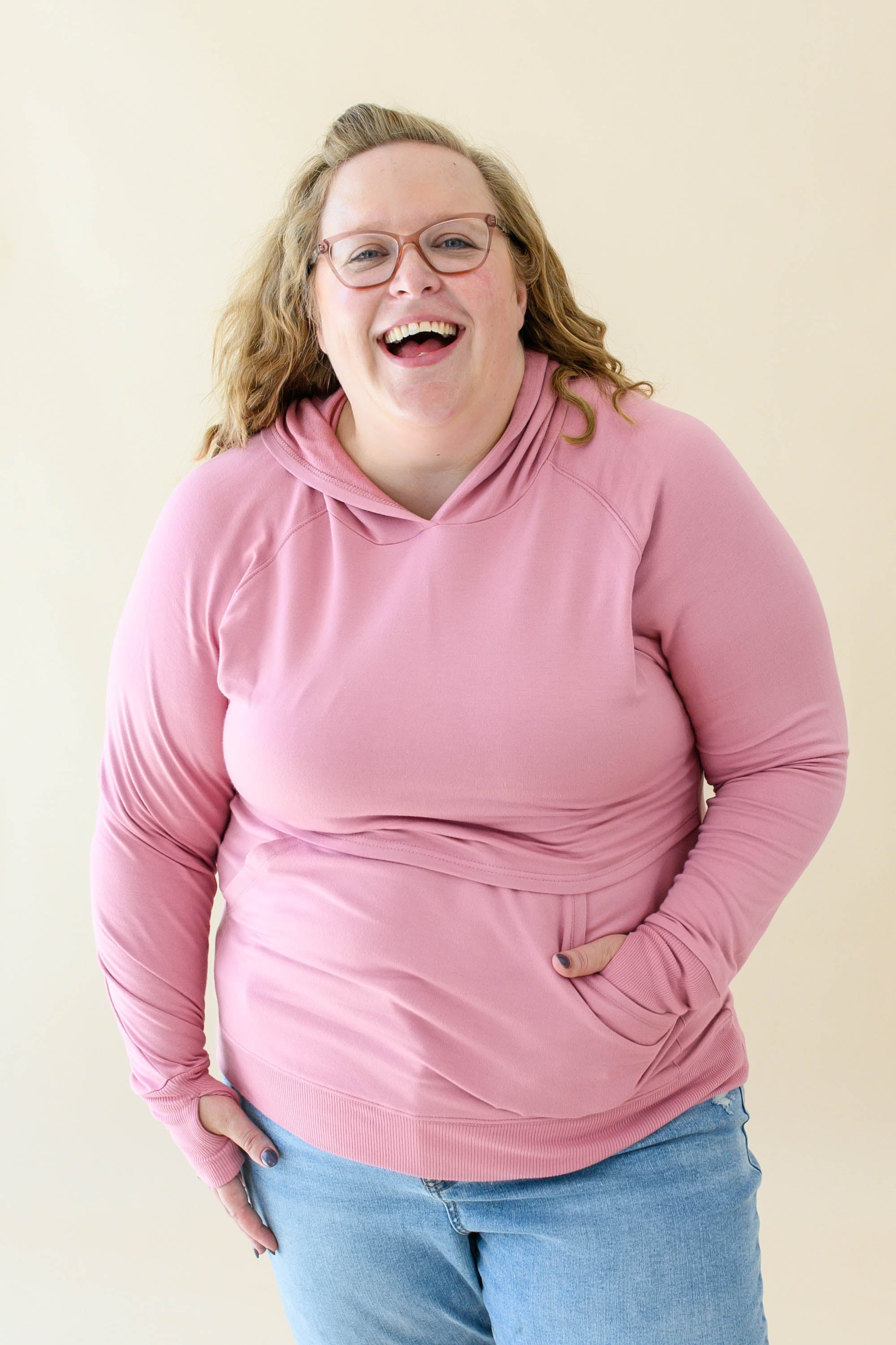Female wearing the Women's French Terry Nursing Hoodie in Apple Blossom in light wash jeans