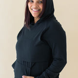 Model wearing the Women's French Terry Nursing Hoodie in Midnight with the hood up
