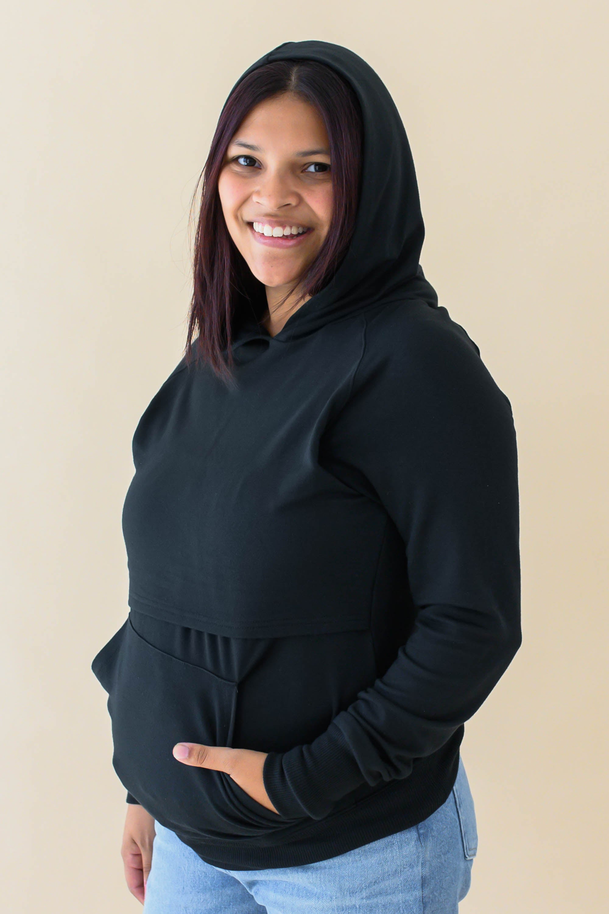 Model wearing the Women's French Terry Nursing Hoodie in Midnight with the hood up