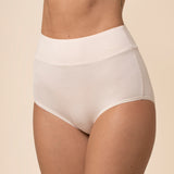 Cream high-waisted underwear worn by a person on a beige background