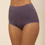 Purple high-waisted underwear worn by a person on a beige background