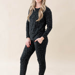 Model wearing Kyte Baby's Women's Jogger Pajama Set in Midnight Leopard