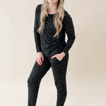 Smiling model wearing Women's Jogger Pajama Set in Midnight Leopard with one hand in pant pocket