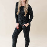 Smiling model wearing Women's Jogger Pajama Set in Midnight Leopard with one hand in pant pocket