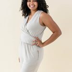 Smiling model wearing the Women's Jumpsuit in Almond with one hand on hip