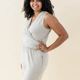 Smiling model wearing the Women's Jumpsuit in Almond with one hand on hip
