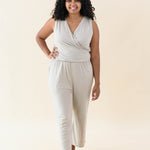 Model walking in the Women's Jumpsuit in Almond with one hand on hip