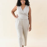 Model walking in the Women's Jumpsuit in Almond with one hand on hip