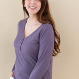 Female model wearing the Women's Long Sleeve Henley Tee in Currant