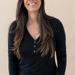 Model wearing the Women's Long Sleeve Henley Tee in Midnight and jeans