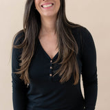 Model wearing the Women's Long Sleeve Henley Tee in Midnight and jeans