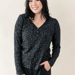 Female modeling the Women's Long Sleeve Henley Tee in Midnight Leopard