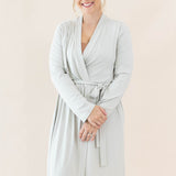 Smiling model wearing the Women’s Lounge Robe in Oat 