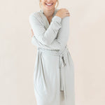Female hugging herself wearing the Women’s Lounge Robe in Oat