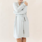 Female model hugging herself wearing the Women’s Lounge Robe in Oat