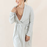 Model wearing the Women’s Lounge Robe in Oat with the shoulder of the robe pulled a bit off to the side