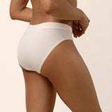 Light beige bamboo midi brief underwear worn by a person on a beige background showing back coverage