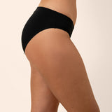 Black bamboo midi brief underwear worn by a person on a beige background showing side coverage