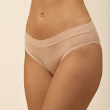 Beige underwear worn by a person on a beige background