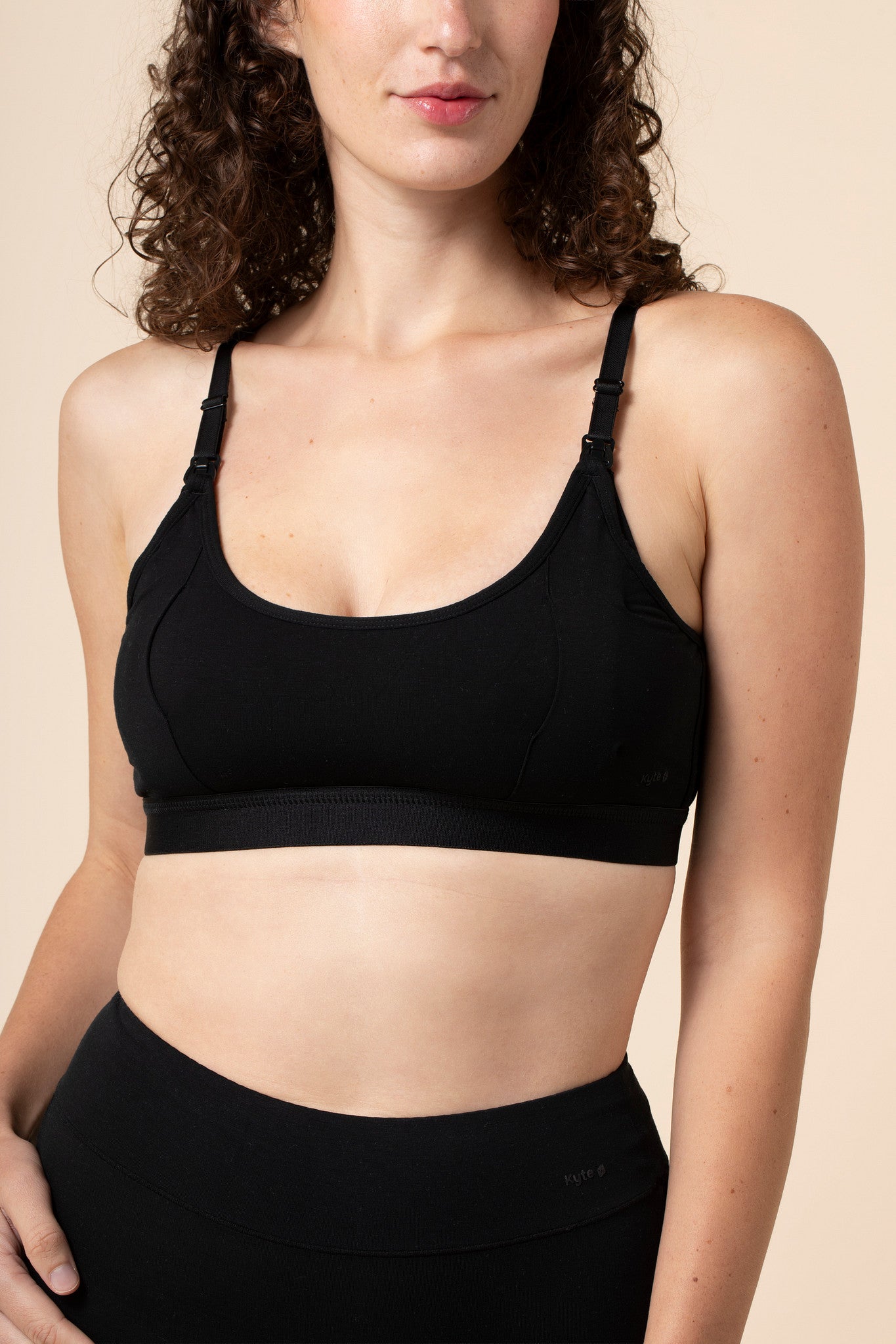 Model wearing the Women's Pumping Bra in Midnight paired with matching underwear 
