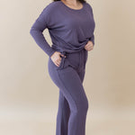 Model wearing the Women's Ribbed High Waisted Wide Leg Pant in Currant with one hand in pocket