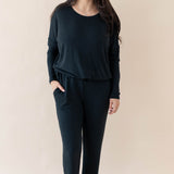 Model wearing the Women's Ribbed High Waisted Wide Leg Pant in Midnight with one hand in pants pocket