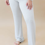 Model wearing Women's Ribbed High Waisted Wide Leg Pant in Oat with one hand on thigh