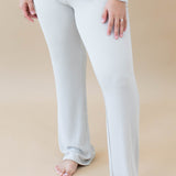 Model wearing Women's Ribbed High Waisted Wide Leg Pant in Oat with one hand on thigh