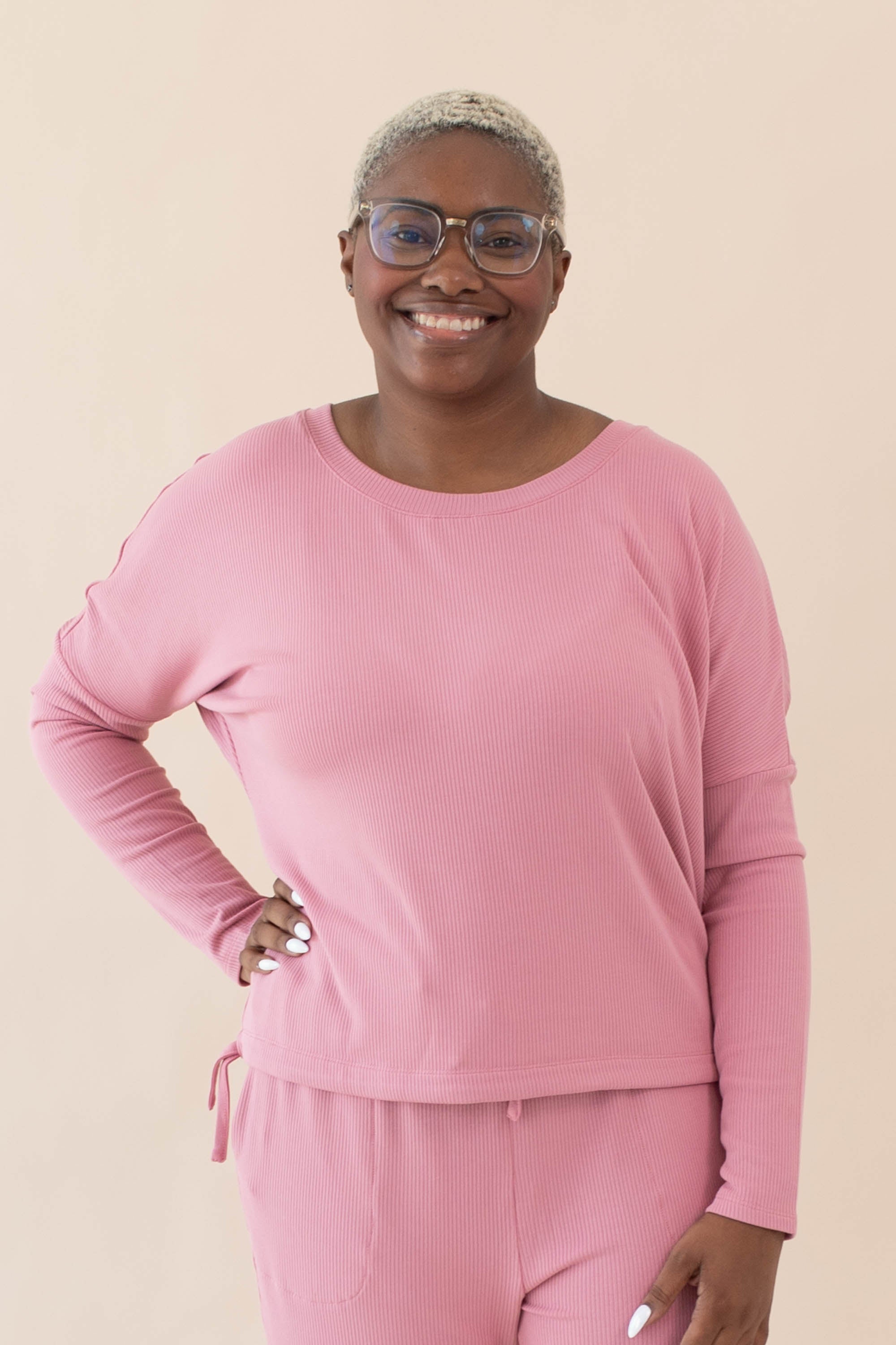 Model wearing the Women's Ribbed Long Sleeve Drop Shoulder Top in Apple Blossom paired with Apple Blossom pants