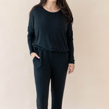 Female modeling the Women's Ribbed Long Sleeve Drop Shoulder Top in Midnight paired with Midnight Wide Leg Pants