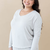 Female modeling the Women's Ribbed Long Sleeve Drop Shoulder Top in Oat paired with Oat Jogger Pants