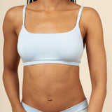 Close up of a model wearing the Women's Scoop Neck Bralette in Breeze  paired with matching briefs ::: Model is 32C" wearing size S ///