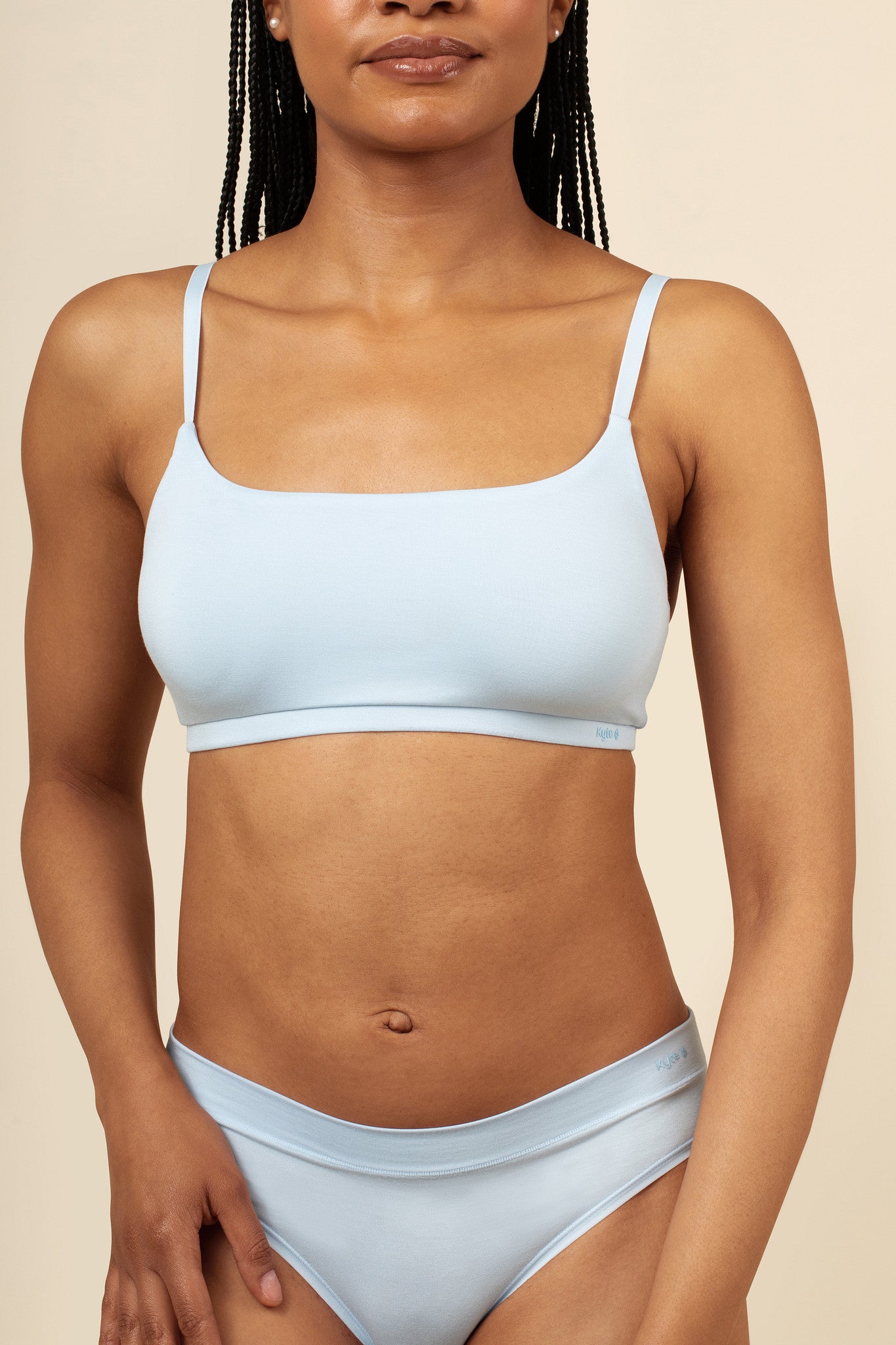 Close up of a model wearing the Women's Scoop Neck Bralette in Breeze  paired with matching briefs 