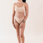 Model wearing Kyte Baby's Women's Scoop Neck Bralette in Chai