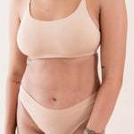 Close up of model wearing Kyte Baby's Women's Scoop Neck Bralette in Chai